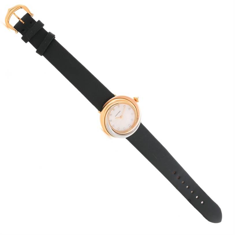 The image shows the Cartier Trinity W200246 Women's Yellow Gold Beige Dial W200246 Women's Yellow Gold Beige Dial model watch from a top-down angle, highlighting the black strap, round gold case, and white dial.