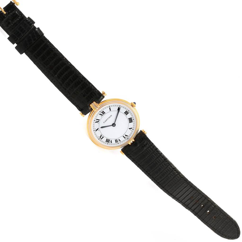 The Cartier Trinity W1514457 Yellow Gold White Dial W1514457 Yellow Gold White Dial watch is shown from a top-down angle, featuring the face, hands, and full strap.