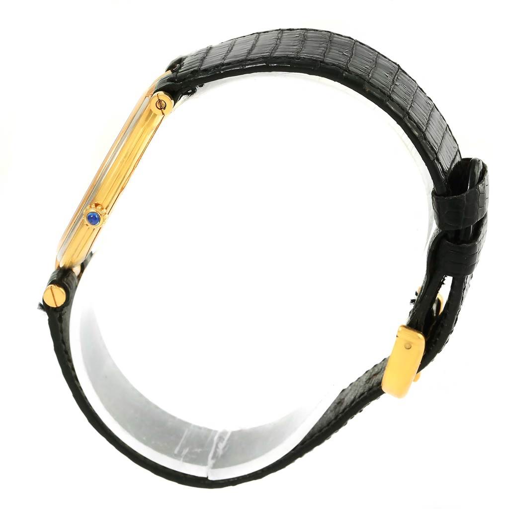 The image shows a side view of the Cartier Trinity W1514457 Yellow Gold White Dial W1514457 Yellow Gold White Dial watch, highlighting its gold case, crown, and black leather strap.