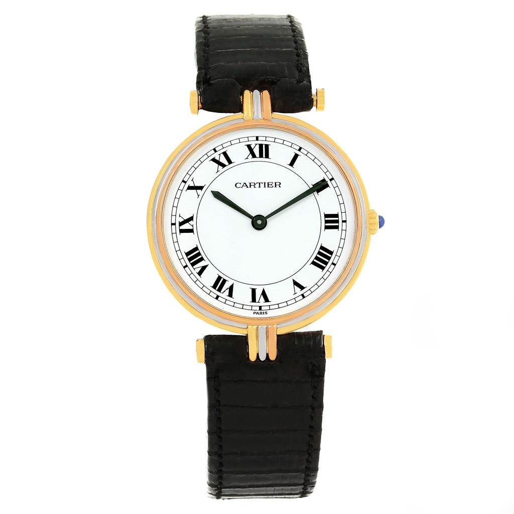 The image shows a frontal view of a Cartier Trinity W1514457 Yellow Gold White Dial W1514457 Yellow Gold White Dial model watch, displaying its white dial, Roman numerals, and black leather strap.