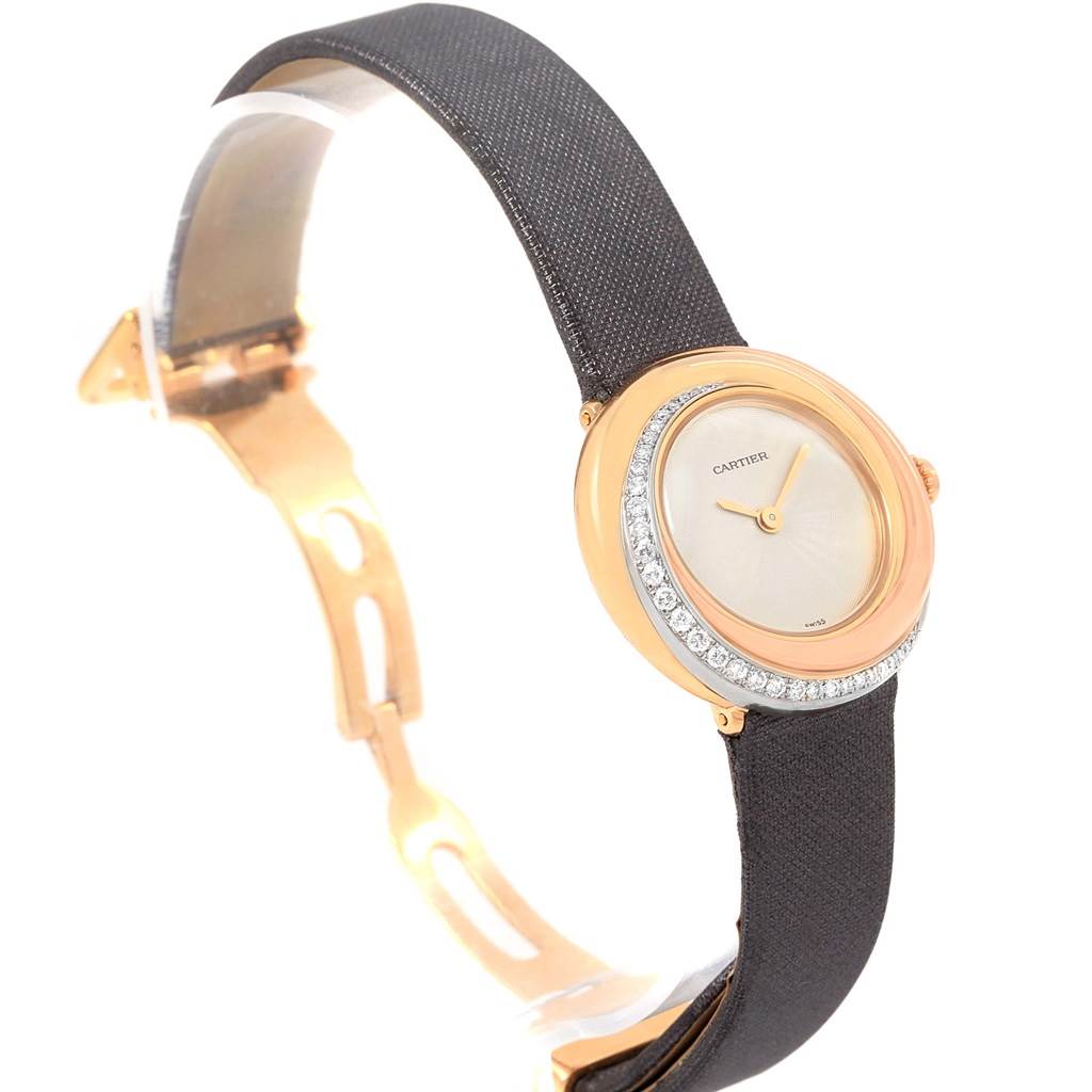 This Cartier Trinity WG200151 Women's Yellow Gold Beige Dial WG200151 Women's Yellow Gold Beige Dial model watch is shown at an angle highlighting its round face, diamond bezel, and black strap.