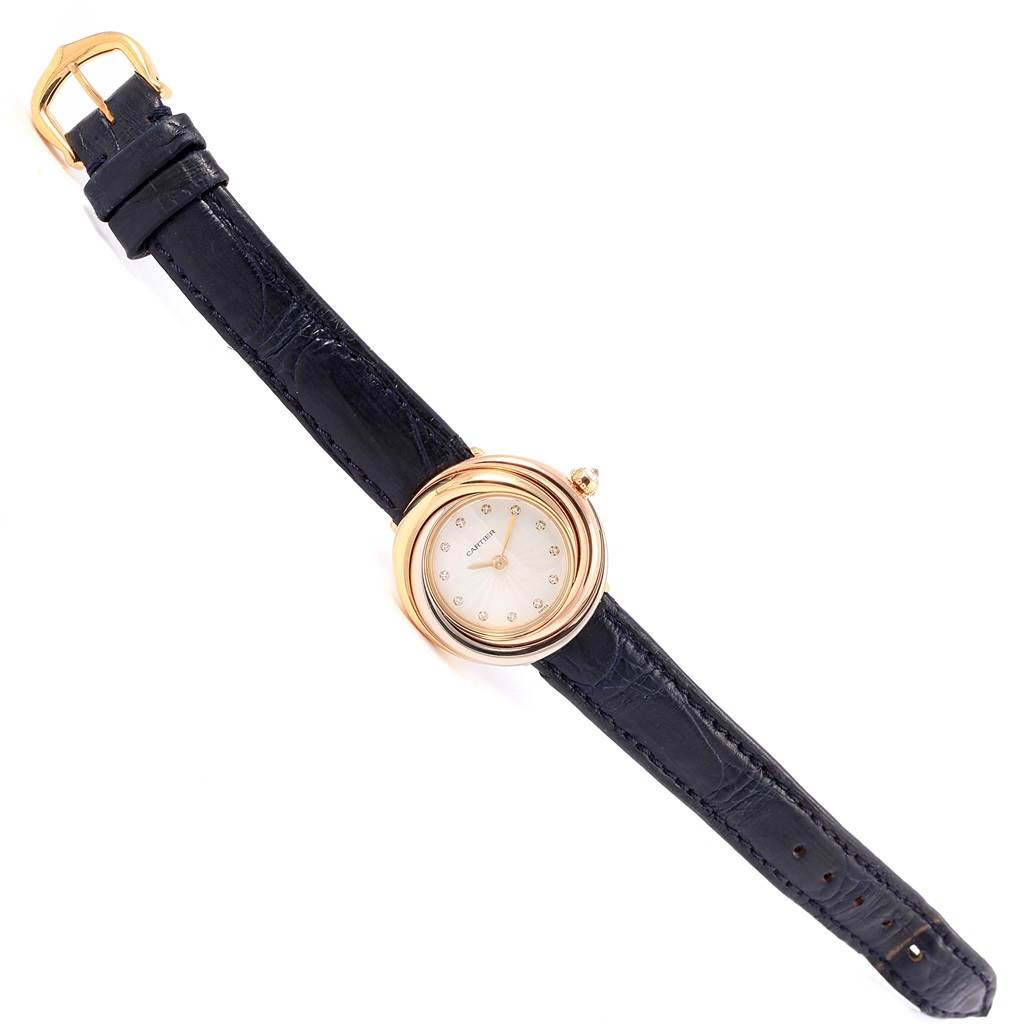 The image shows a top view of a Cartier Trinity W200246 Women's Yellow Gold Beige Dial W200246 Women's Yellow Gold Beige Dial model watch, highlighting its black strap and gold round face with a white dial.