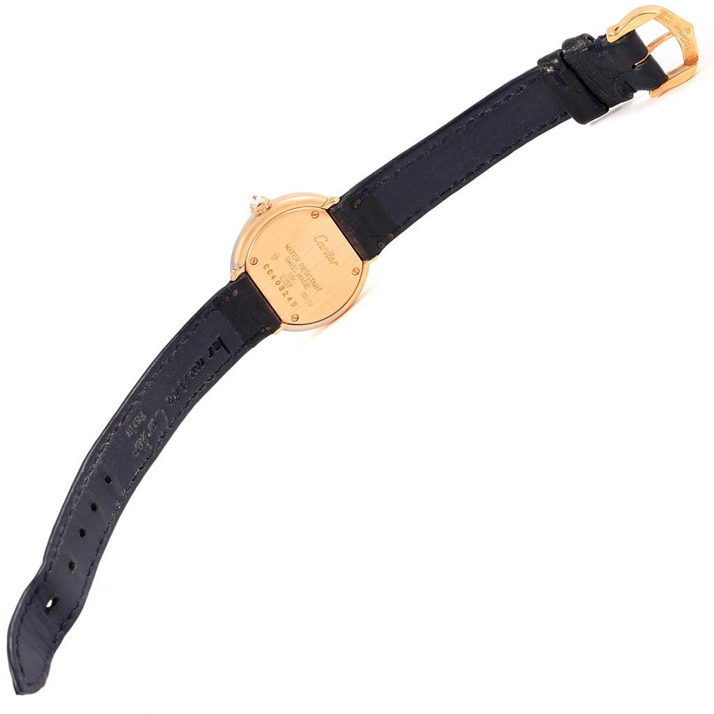 The image shows the back side of a Trinity model watch by Cartier, including its strap and buckle.