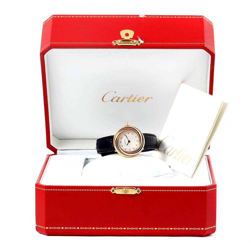 The Cartier Trinity W200246 Women's Yellow Gold Beige Dial W200246 Women's Yellow Gold Beige Dial model watch is shown in an open red Cartier box with an instruction manual.