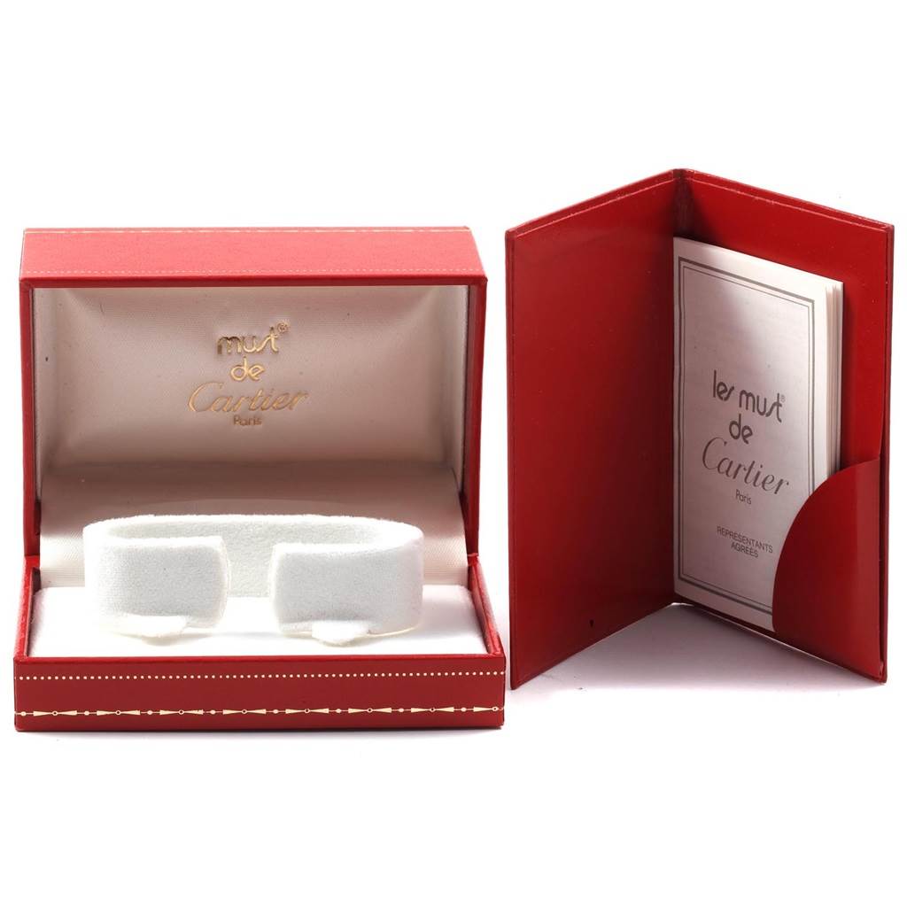 The image shows the empty red box and warranty booklet for a Cartier Trinity W200246 Women
s Yellow Gold Beige Dial W200246 Women
s Yellow Gold Beige Dial watch.
