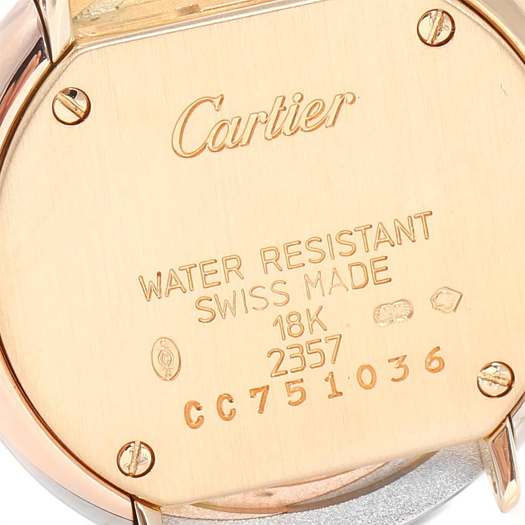 This image shows the back case of a Trinity model watch by Cartier, highlighting its inscriptions and screws.