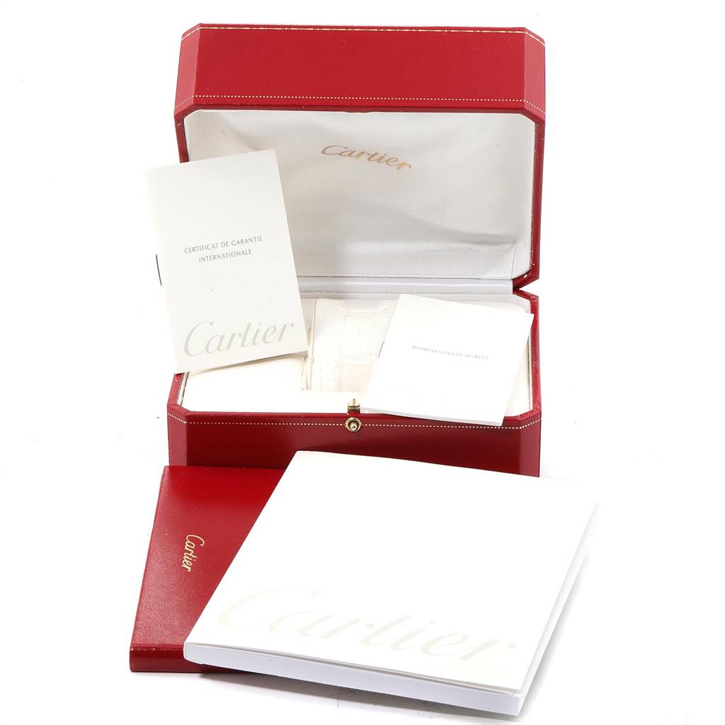This image shows the packaging and accessories for a Cartier Trinity WG200151 Women's Yellow Gold Beige Dial WG200151 Women's Yellow Gold Beige Dial model watch, including a red box, manuals, and warranty papers.