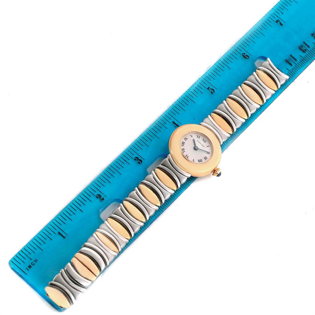 The Cartier Colisee 1335 Women's Yellow Gold Silver Dial 1335 Women's Yellow Gold Silver Dial model watch is shown lying flat with a blue ruler for scale.