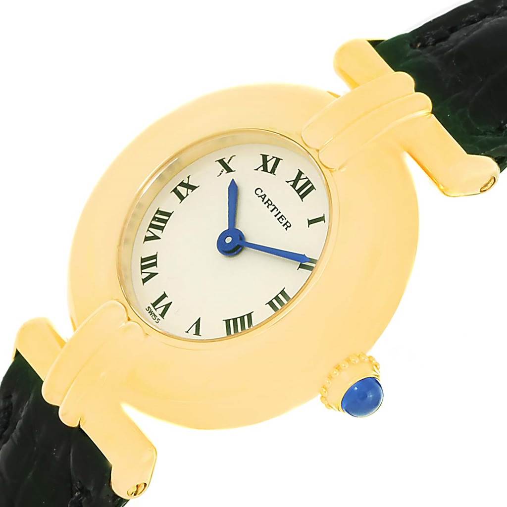 The Colisee model by Cartier is shown at an angle highlighting the gold case, white dial with Roman numerals, and blue stone-set crown.