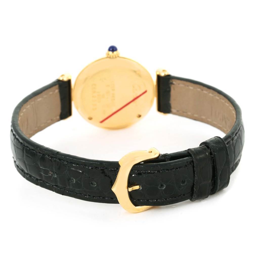 The image shows the back view of a Cartier Colisee Women's Yellow Gold Silver Dial Women's Yellow Gold Silver Dial watch, featuring its gold case, black leather strap, and gold buckle.