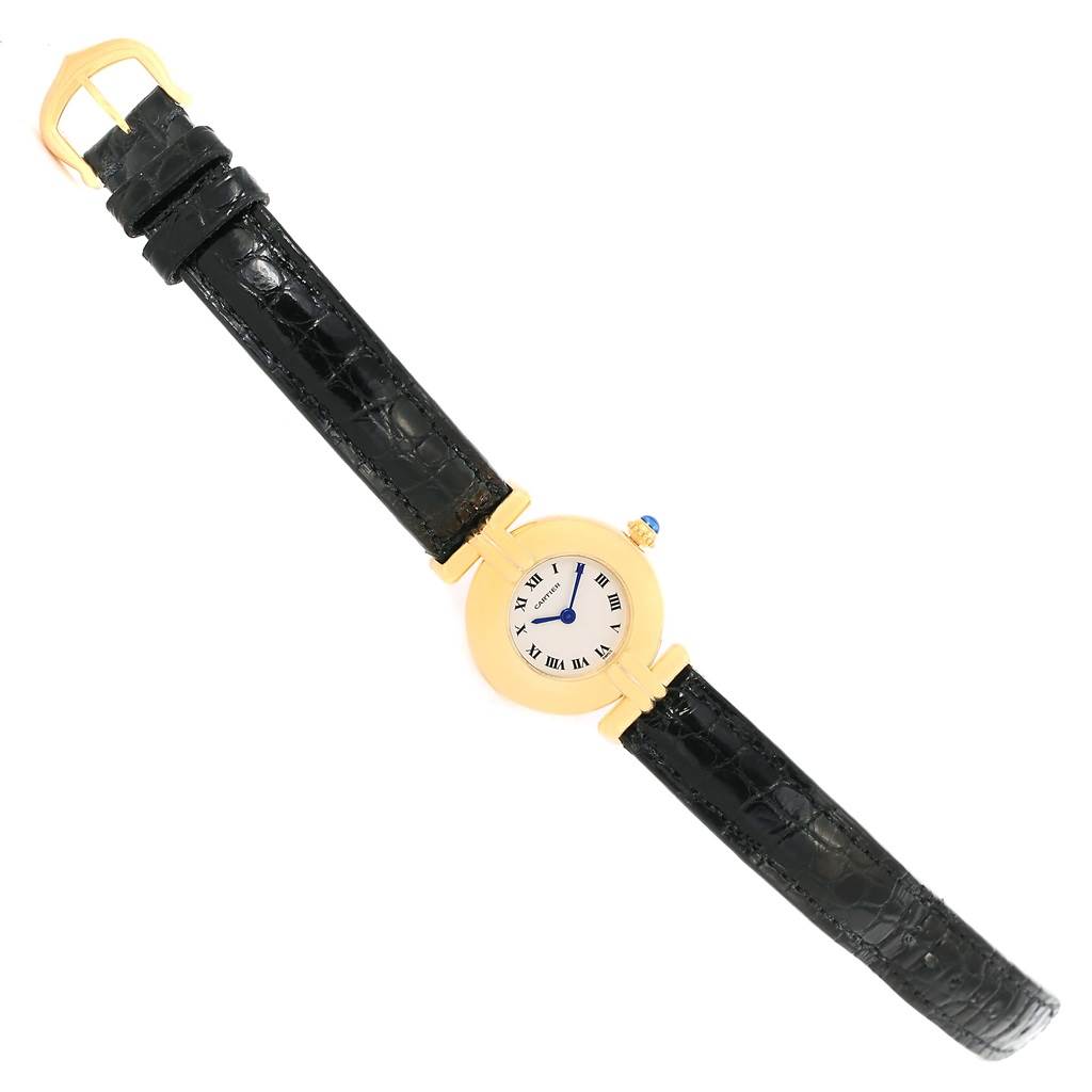 The Cartier Colisee Women's Yellow Gold Silver Dial Women's Yellow Gold Silver Dial model watch is shown from a top-down angle, displaying its round gold case, white dial with Roman numerals, and black leather strap.