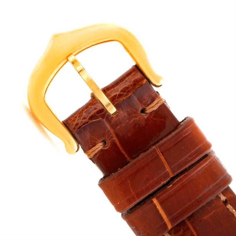 The image shows a close-up of a brown leather strap and gold buckle of a Cartier Colisee C28086 Women's Yellow Gold Silver Dial C28086 Women's Yellow Gold Silver Dial model watch.