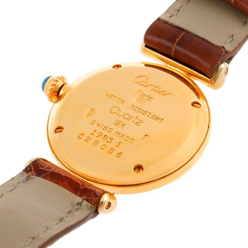The image shows the back of a Cartier Colisee C28086 Women's Yellow Gold Silver Dial C28086 Women's Yellow Gold Silver Dial model watch, featuring its gold case, leather straps, and engraved details.