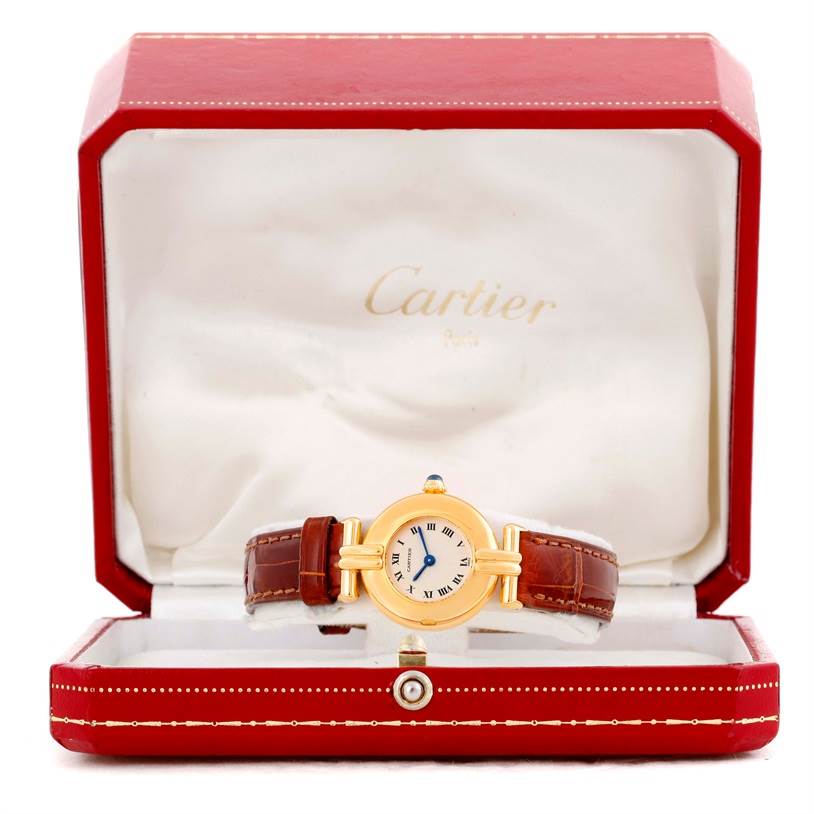 The Cartier Colisee C28086 Women's Yellow Gold Silver Dial C28086 Women's Yellow Gold Silver Dial watch is shown in its open red case, displaying the face, bezel, and the leather strap.