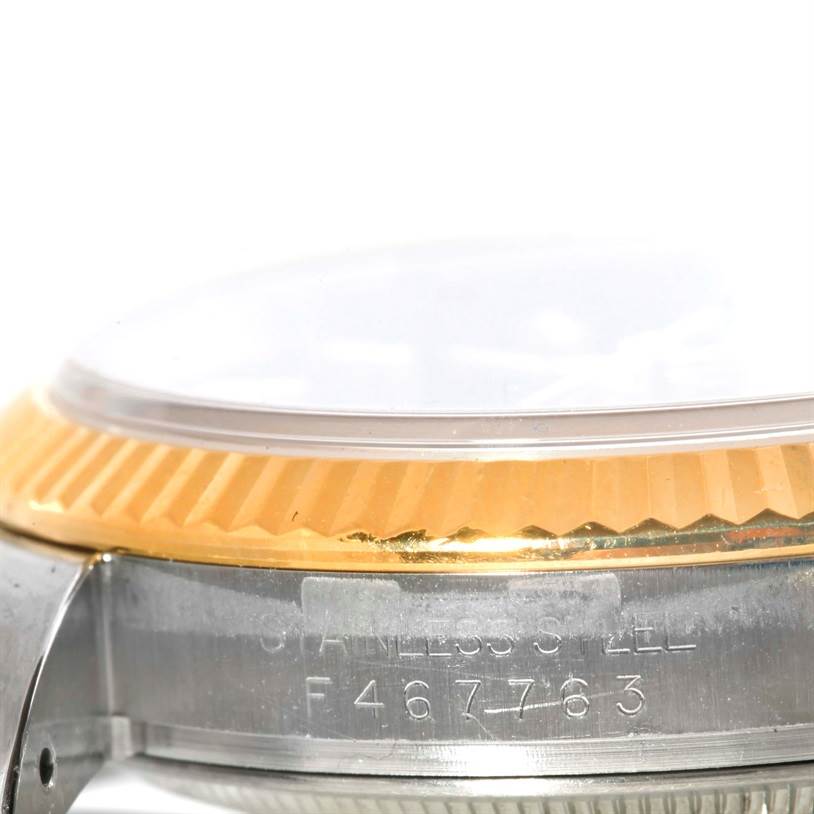 The image shows a close-up, side view of a Rolex Datejust 116233 Men's Stainless Steel Blue Dial 116233 Men's Stainless Steel Blue Dial watch's case, bezel, and crystal.