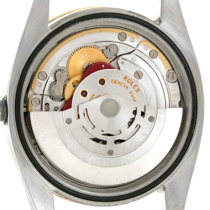 The image shows the backside of the Rolex Datejust 116233 Men's Stainless Steel Blue Dial 116233 Men's Stainless Steel Blue Dial watch, revealing its movement and internal mechanical components.