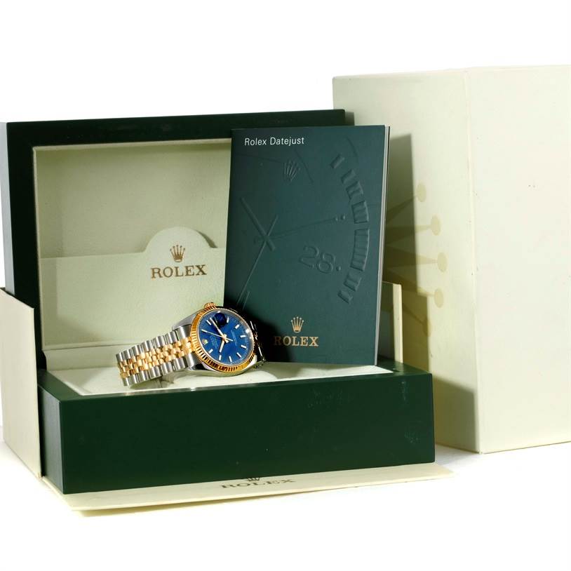 The image shows a Rolex Datejust 116233 Men's Stainless Steel Blue Dial 116233 Men's Stainless Steel Blue Dial watch with a two-tone bracelet, alongside its open green box and accompanying paperwork.