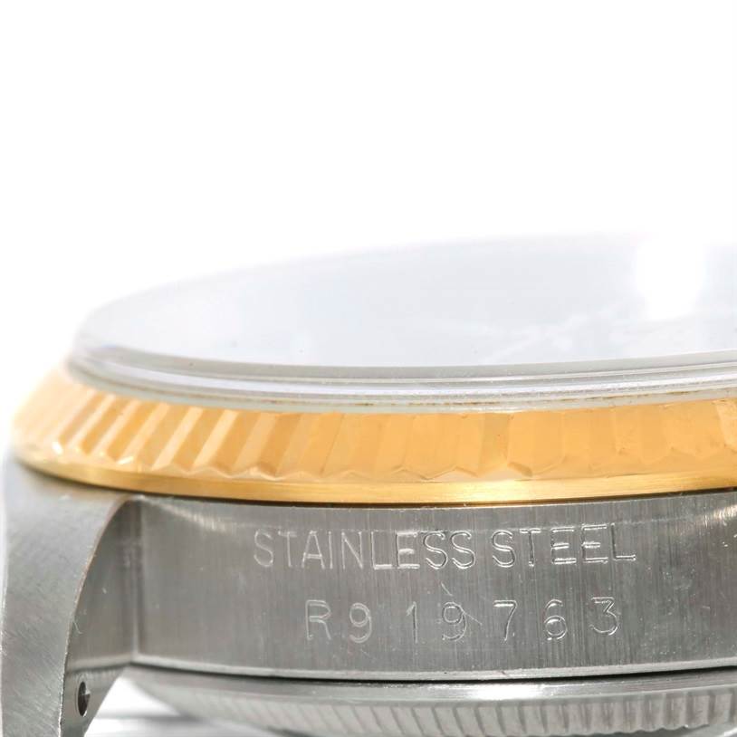 This image shows a detailed side view of the bezel and part of the case of a Rolex Datejust 16233 Men's Steel and Gold (two tone) Black Dial 16233 Men's Steel and Gold (two tone) Black Dial watch, displaying the stainless steel material.