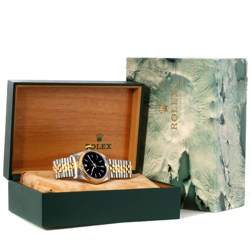 The Rolex Datejust 16233 Men's Steel and Gold (two tone) Black Dial 16233 Men's Steel and Gold (two tone) Black Dial watch is shown inside its open box, placed on its side and partially rolled watch pillow.