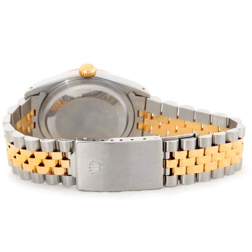 This image shows the back case and two-tone metal bracelet of a Rolex Datejust 16233 Men's Steel and Gold (two tone) Black Dial 16233 Men's Steel and Gold (two tone) Black Dial watch.