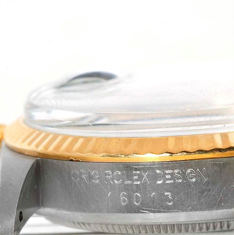 The image shows a close-up side view of the Rolex Datejust 16013 Men's Stainless Steel Champagne Dial 16013 Men's Stainless Steel Champagne Dial 16013 model's case, highlighting the bezel and engraved text.