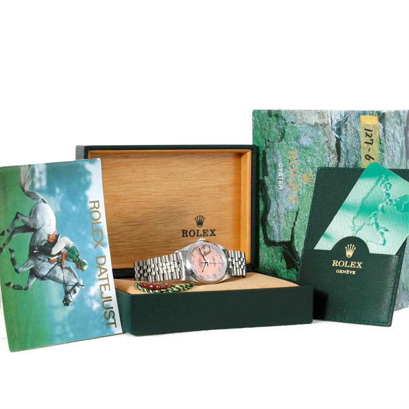 The image shows a Rolex Datejust 16200 Men
s Stainless Steel Pink Dial 16200 Men
s Stainless Steel Pink Dial watch with box, warranty card, and instruction booklet from a front angle.