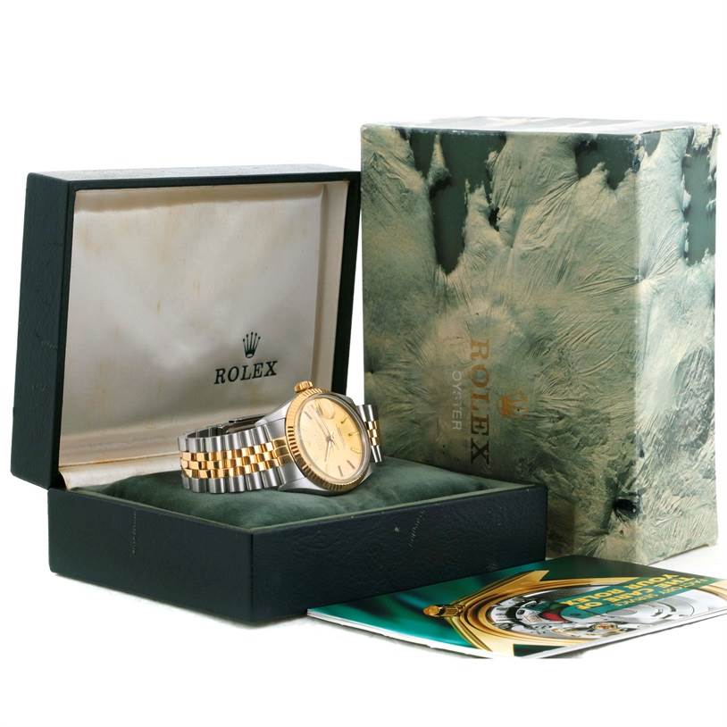 The Rolex Datejust 16013 Men's Stainless Steel Champagne Dial 16013 Men's Stainless Steel Champagne Dial watch is shown at an angle displaying its face, bracelet, and original packaging, including the box and booklet.