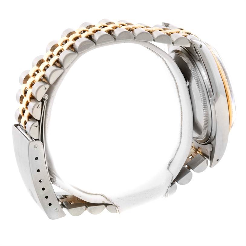 The image shows a side view of a Rolex Datejust 16013 Men's Stainless Steel Champagne Dial 16013 Men's Stainless Steel Champagne Dial watch, highlighting its two-tone metal bracelet and case.