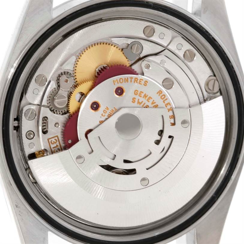 The image shows the intricate inner mechanism of a Rolex Datejust 16220 Men's Stainless Steel Silver Dial 16220 Men's Stainless Steel Silver Dial watch from a rear angle, revealing gears and the winding rotor.