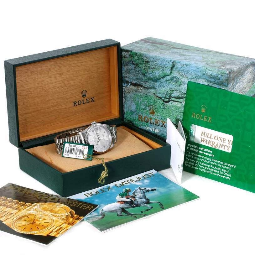 The Rolex Datejust 16220 Men's Stainless Steel Silver Dial 16220 Men's Stainless Steel Silver Dial watch is displayed in its open box with accompanying warranty card and brochures.