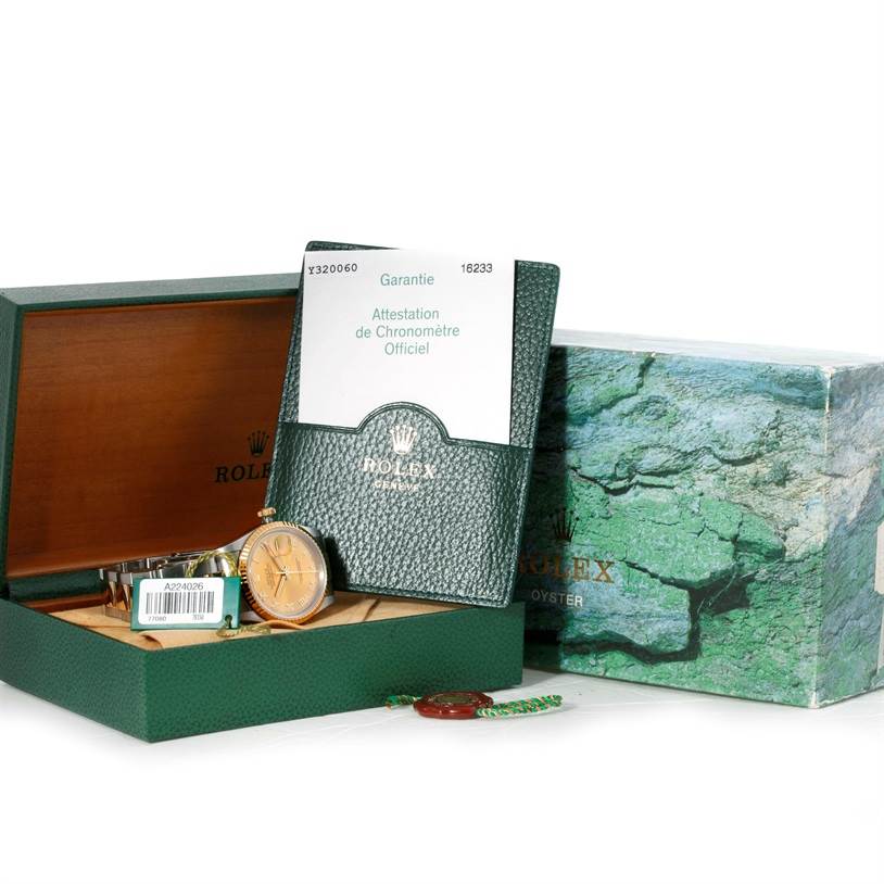 This image shows a Rolex Datejust 16233 Men's Steel and Gold (two tone) Champagne Dial 16233 Men's Steel and Gold (two tone) Champagne Dial watch with its open box, papers, and accessories, including the warranty card holder.
