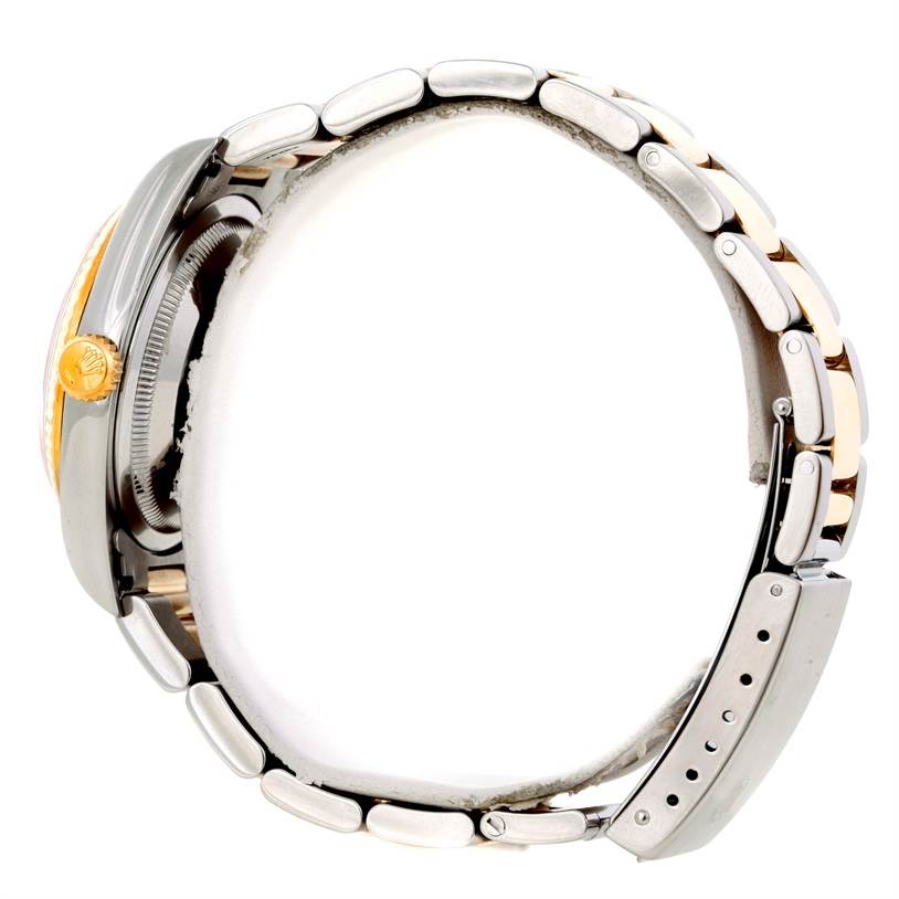 The Rolex Datejust 16233 Men's Steel and Gold (two tone) Champagne Dial 16233 Men's Steel and Gold (two tone) Champagne Dial watch is shown from a side angle, highlighting its crown, bezel, and partially opened bracelet.