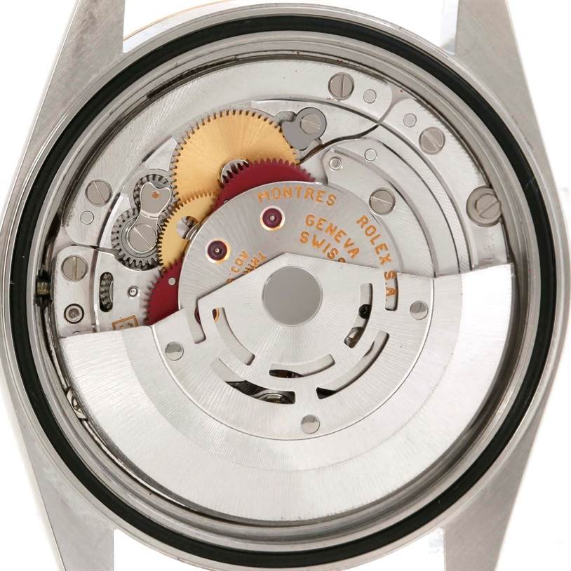 The image shows the internal mechanism of a Rolex Datejust 16233 Men's Steel and Gold (two tone) Champagne Dial 16233 Men's Steel and Gold (two tone) Champagne Dial watch, viewed from the back, displaying gears and movement parts.