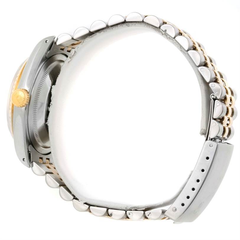 The image shows a side view of a Rolex Datejust 16233 Men's Steel and Gold (two tone) Champagne Dial 16233 Men's Steel and Gold (two tone) Champagne Dial watch, highlighting the crown, case, and bracelet.