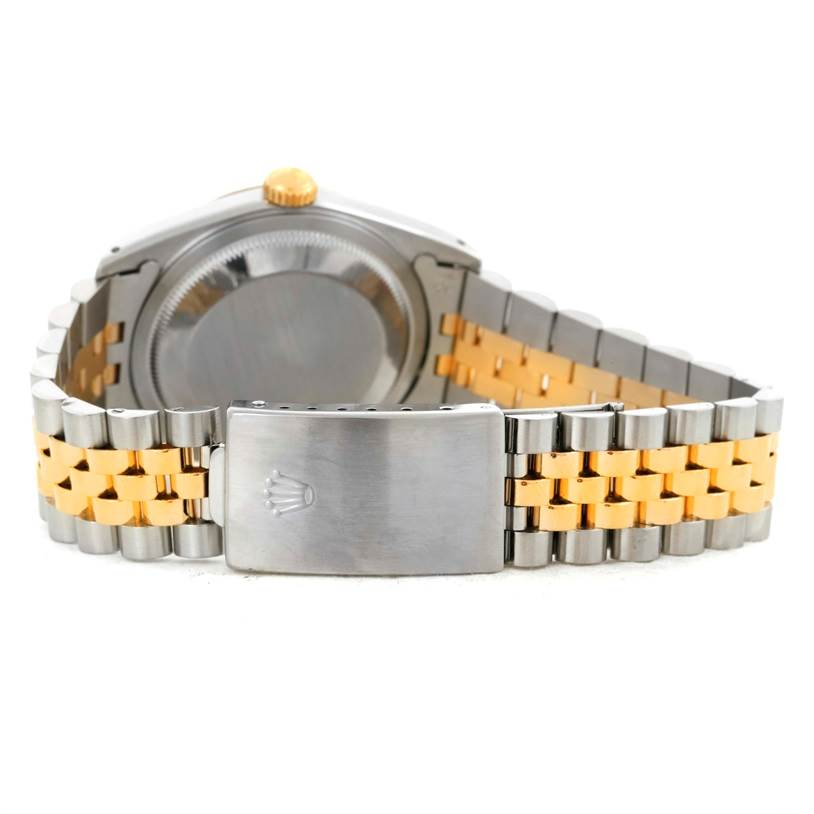 The image shows the back side of a Rolex Datejust 16233 Men's Steel and Gold (two tone) Champagne Dial 16233 Men's Steel and Gold (two tone) Champagne Dial watch, featuring its clasp and two-tone metal bracelet.