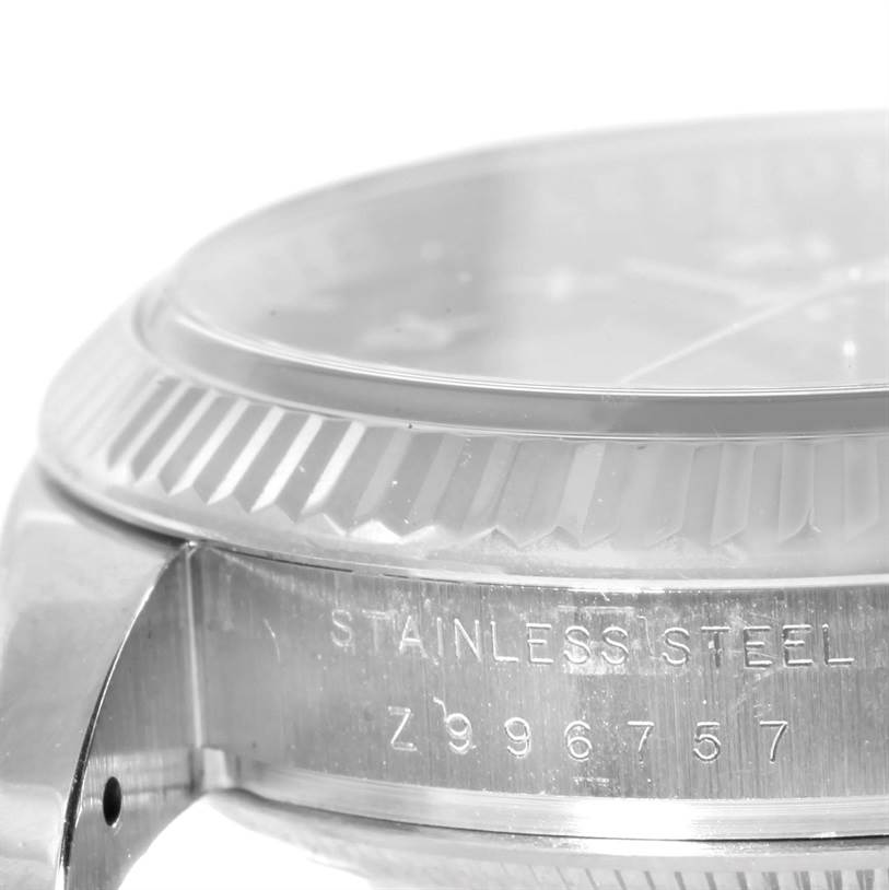 This image shows a close-up of the case and part of the bezel of a Rolex Datejust 115234 Men
s Stainless Steel Black Dial 115234 Men
s Stainless Steel Black Dial watch, highlighting the model inscription.