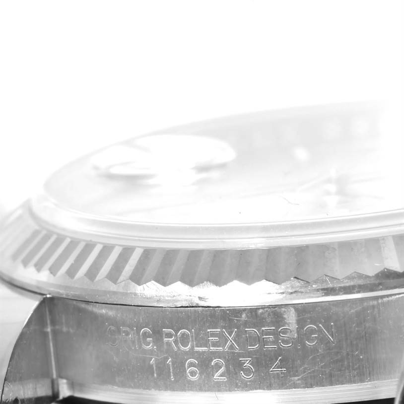 The image shows a close-up of the side profile of a Rolex Datejust 116234 Men's Stainless Steel Silver Dial 116234 Men's Stainless Steel Silver Dial watch, highlighting the bezel and serial number.