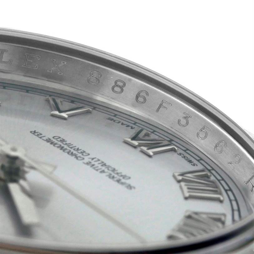 This close-up image of a Rolex Datejust 116234 Men's Stainless Steel Silver Dial 116234 Men's Stainless Steel Silver Dial model shows part of the dial and the inner bezel with serial numbers.