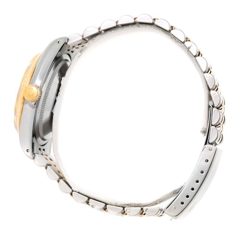 This side view of the Rolex Datejust 16233 Men's Steel and Gold (two tone) Champagne Dial 16233 Men's Steel and Gold (two tone) Champagne Dial shows its bracelet, crown, and a portion of the case.