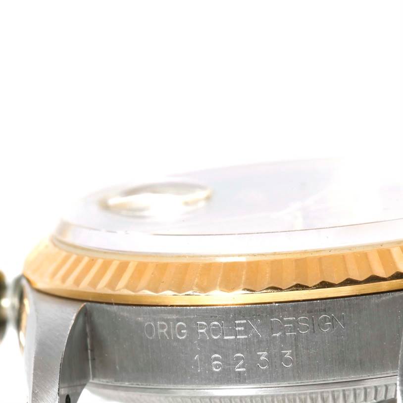 This image shows a close-up side angle of a Rolex Datejust 16233 Men's Steel and Gold (two tone) Champagne Dial 16233 Men's Steel and Gold (two tone) Champagne Dial watch, focusing on its case and serial number.