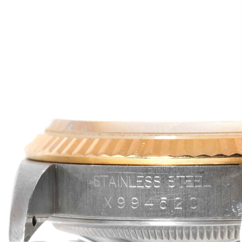 This close-up image of a Rolex Datejust 16233 Men's Steel and Gold (two tone) Champagne Dial 16233 Men's Steel and Gold (two tone) Champagne Dial watch shows part of the case with the serial number engraving.