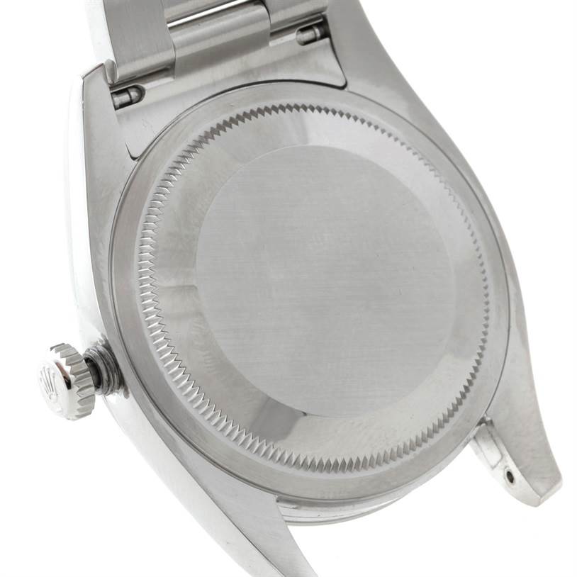 This image shows the back case and crown of a Rolex Datejust 116200 Men
s Stainless Steel Grey Dial 116200 Men
s Stainless Steel Grey Dial watch from a tilted angle.