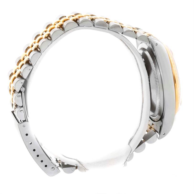 This side view of the Rolex Datejust 16233 Men's Steel and Gold (two tone) Champagne Dial 16233 Men's Steel and Gold (two tone) Champagne Dial watch focuses on the clasp and bracelet.