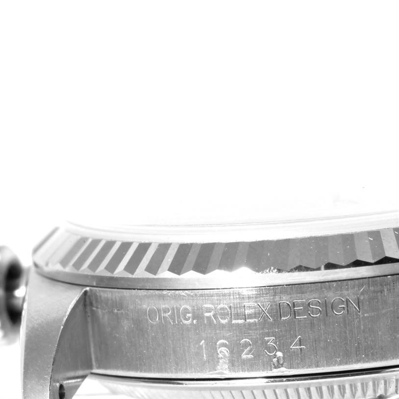 The image shows a close-up view of the side of a Rolex Datejust 16234 Men's Stainless Steel Silver Dial 16234 Men's Stainless Steel Silver Dial, featuring the fluted bezel and engraved case with the text "ORIG. ROLEX DESIGN 16234."