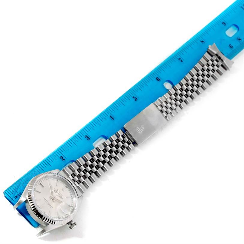 The image shows a Rolex Datejust 16234 Men's Stainless Steel Silver Dial 16234 Men's Stainless Steel Silver Dial watch laid flat with its bracelet extended next to a blue ruler for measurement.