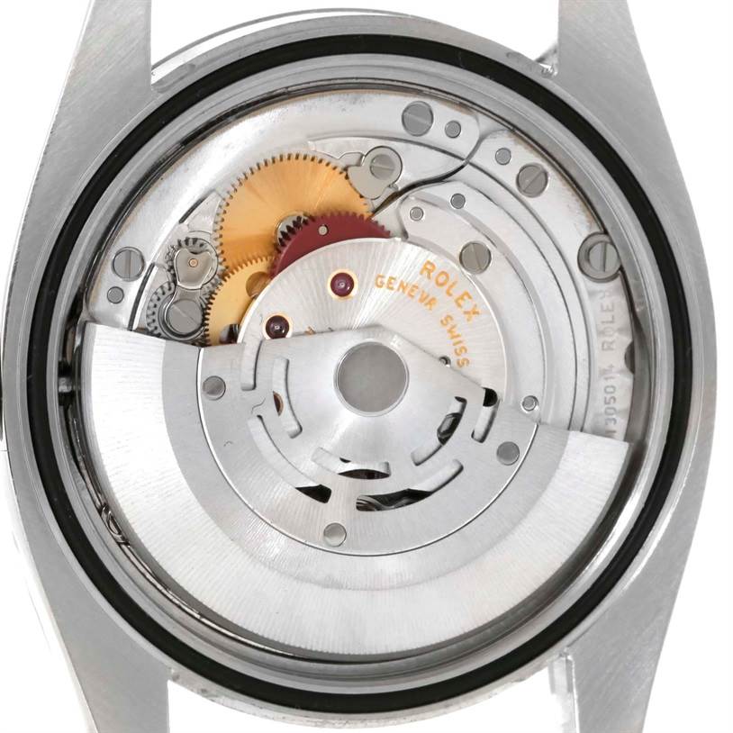 The image shows the internal mechanism of a Rolex Datejust 116234 Men
s Stainless Steel Black Dial 116234 Men
s Stainless Steel Black Dial watch from the back, featuring its intricate gears and parts.