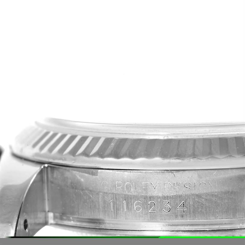 This image shows a close-up side view of the case and bezel of a Rolex Datejust 116234 Men
s Stainless Steel Black Dial 116234 Men
s Stainless Steel Black Dial model, revealing the engraved serial number.