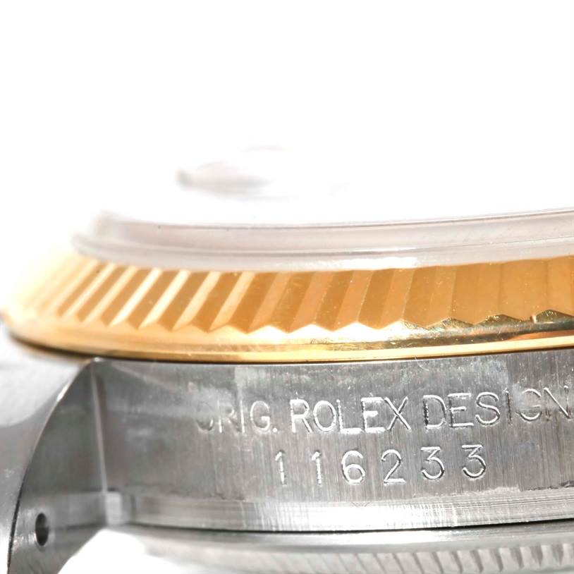 This image shows a close-up of the Rolex Datejust 116233 Men's Stainless Steel Blue Dial 116233 Men's Stainless Steel Blue Dial's fluted bezel and case, highlighting the engraved model number 116233.