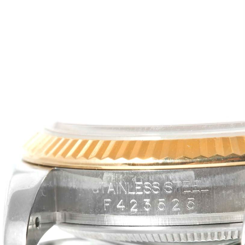 This image shows a close-up side view of the bezel and case of a Rolex Datejust 116233 Men's Stainless Steel Blue Dial 116233 Men's Stainless Steel Blue Dial watch, highlighting the serial number and stainless steel construction.