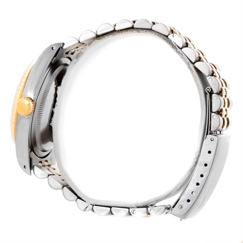 This image of a Rolex Datejust 16233 Men's Steel and Gold (two tone) Champagne Dial 16233 Men's Steel and Gold (two tone) Champagne Dial watch is taken from the side, showing the crown, case, and bracelet.